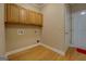 Laundry room with wooden cabinets and hardwood floors at 1041 Flat Rock Rd, Covington, GA 30014