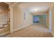 The room has a staircase, door, carpet, base molding and a partial view of another room at 1041 Flat Rock Rd, Covington, GA 30014