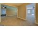 The living room has tan carpet and a view into two other rooms with ceiling fans at 1041 Flat Rock Rd, Covington, GA 30014