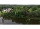 Idyllic aerial view of lakeside homes nestled among lush trees, offering a peaceful and private retreat by the water at 81 Smokerise Pt, Peachtree City, GA 30269