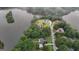 Aerial view of real estate with beautiful homes and lush trees by the lake at 81 Smokerise Pt, Peachtree City, GA 30269
