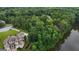 Breathtaking aerial view of a home near a tranquil lake surrounded by lush greenery, showcasing a serene and private setting at 81 Smokerise Pt, Peachtree City, GA 30269
