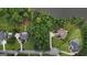 Majestic aerial view of a neighborhood with lush lawns, mature trees, and serene lake, offering a peaceful and private setting at 81 Smokerise Pt, Peachtree City, GA 30269
