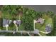 Overhead shot of multiple large homes on sprawling lots, showing lush landscaping and access to a serene lake at 81 Smokerise Pt, Peachtree City, GA 30269