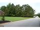 Expansive front yard featuring a well-manicured lawn and mature trees in a desirable neighborhood at 81 Smokerise Pt, Peachtree City, GA 30269