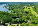 An aerial view shows the neighborhood, surrounding trees, golf course, and access to the lake at 7003 Tara Dr, Villa Rica, GA 30180