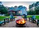 Backyard with a cozy fire pit area surrounded by Adirondack chairs, ideal for relaxing evenings at 7003 Tara Dr, Villa Rica, GA 30180