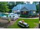 Expansive backyard featuring a swimming pool, outdoor seating, and a well-manicured lawn, perfect for entertaining at 7003 Tara Dr, Villa Rica, GA 30180