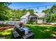 Backyard featuring an outdoor dining area, ideal for gatherings in a serene setting at 7003 Tara Dr, Villa Rica, GA 30180