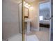 Bathroom features a pedestal sink, gold-trimmed shower, and a large vanity mirror at 7003 Tara Dr, Villa Rica, GA 30180