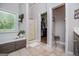 Bright bathroom featuring a large tub, tiled floors, and a convenient walk-in closet at 7003 Tara Dr, Villa Rica, GA 30180