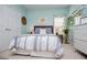 Cozy bedroom featuring natural light, a bed with charming decor, and lush plants at 7003 Tara Dr, Villa Rica, GA 30180