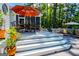 Inviting outdoor deck with dining set, perfect for entertaining against a wooded backdrop at 7003 Tara Dr, Villa Rica, GA 30180