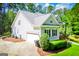 Well-maintained exterior with a side-entry garage, lush landscaping, and a neatly paved driveway at 7003 Tara Dr, Villa Rica, GA 30180