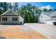 Spacious property featuring a detached garage and ample parking space, surrounded by tall trees at 7003 Tara Dr, Villa Rica, GA 30180