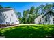 Well-maintained lawn connecting the house and detached garage, with lush trees for added privacy at 7003 Tara Dr, Villa Rica, GA 30180