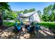 Inviting outdoor fire pit area with Adirondack chairs, screened porch and spacious backyard at 7003 Tara Dr, Villa Rica, GA 30180