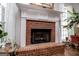 Classic brick fireplace with white mantle in a bright, cozy setting at 7003 Tara Dr, Villa Rica, GA 30180