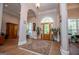 Elegant foyer with hardwood floors, arched entryway, and a decorative front door with transom window at 7003 Tara Dr, Villa Rica, GA 30180
