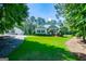 Quaint home and detached garage with a manicured lawn, tall trees, and a welcoming driveway at 7003 Tara Dr, Villa Rica, GA 30180