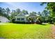 Attractive home with a green lawn, lush trees, and a detached garage, providing ample space at 7003 Tara Dr, Villa Rica, GA 30180