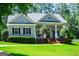 Attractive home featuring black window shutters, complemented by a well-kept lawn and brick accents at 7003 Tara Dr, Villa Rica, GA 30180