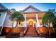 Inviting front porch with brick stairs, detailed railing, and a bright red front door at 7003 Tara Dr, Villa Rica, GA 30180