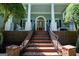 Grand entrance featuring brick stairs leading to a covered porch with elegant columns and a glass-paneled door at 7003 Tara Dr, Villa Rica, GA 30180