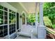 Relaxing front porch with comfortable seating, white columns, and a view of the lush surroundings at 7003 Tara Dr, Villa Rica, GA 30180
