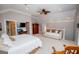 Main bedroom offers a ceiling fan, tv, ensuite entrance, and a relaxing sitting area at 7003 Tara Dr, Villa Rica, GA 30180