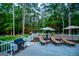 Relaxing patio with lounge chairs, a grill, and a view of the expansive backyard at 7003 Tara Dr, Villa Rica, GA 30180