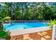Backyard pool offers a refreshing escape, framed by lush landscaping and serene privacy at 7003 Tara Dr, Villa Rica, GA 30180