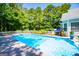 Inviting in-ground pool surrounded by lush greenery and a white picket fence for ultimate relaxation at 7003 Tara Dr, Villa Rica, GA 30180