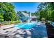 Backyard pool with diving board is complemented by an outdoor deck for sunny gatherings at 7003 Tara Dr, Villa Rica, GA 30180