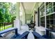 Spacious covered porch with multiple seating areas and views of the lush surrounding landscape at 7003 Tara Dr, Villa Rica, GA 30180