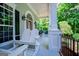 Inviting covered porch with rocking chairs and stylish columns, perfect for relaxing outdoors at 7003 Tara Dr, Villa Rica, GA 30180