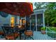 Inviting screened porch with comfortable seating, candle lighting, and a tranquil outdoor ambiance at 7003 Tara Dr, Villa Rica, GA 30180