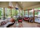 Spacious screened porch featuring comfortable wicker furniture and views of the pool and lush backyard at 7003 Tara Dr, Villa Rica, GA 30180