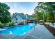 Sparkling swimming pool with lounge chairs, lush landscaping and a serene backyard view at 7003 Tara Dr, Villa Rica, GA 30180