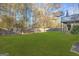 Large, lush green backyard enclosed by a tall wooden fence at 180 Rock Hill Dr, Fayetteville, GA 30215