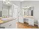 Bright bathroom featuring double sinks, vanities, and a large mirror at 180 Rock Hill Dr, Fayetteville, GA 30215