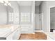 Bright bathroom featuring double sinks, vanities, and a walk-in shower at 180 Rock Hill Dr, Fayetteville, GA 30215
