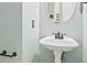 Charming bathroom featuring a pedestal sink with a decorative mirror at 180 Rock Hill Dr, Fayetteville, GA 30215
