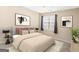 Cozy bedroom with neutral decor, art, and abundant natural light at 180 Rock Hill Dr, Fayetteville, GA 30215