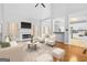 Open living room with fireplace and view of the kitchen at 180 Rock Hill Dr, Fayetteville, GA 30215