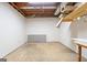 Unfinished basement with concrete floor, white walls, exposed ceiling, and a small window at 185 Downybrook Ln, Fayetteville, GA 30215
