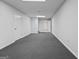 Large finished basement with two doors, gray carpet, and recessed lighting, ideal for recreation or storage at 185 Downybrook Ln, Fayetteville, GA 30215