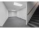 Spacious basement area with carpet and recessed lighting, and an open staircase offering potential for customization at 185 Downybrook Ln, Fayetteville, GA 30215