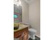 Cozy half bathroom with neutral tones, marble countertop, and a decorative mirror that enhances the space at 185 Downybrook Ln, Fayetteville, GA 30215