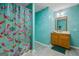 Unique bathroom with colorful fish-themed shower curtain, vanity with a mirror, and vibrant design features at 185 Downybrook Ln, Fayetteville, GA 30215